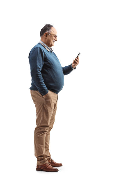 istock Full length profile shot of an elderly man standing and using a mobile phone 1336095174