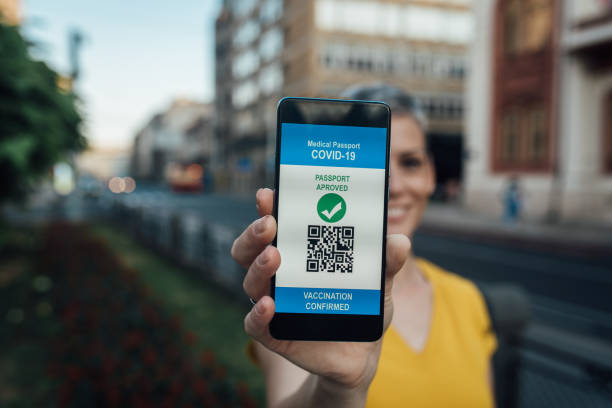 istock Woman showing a smartphone with electronic vaccination certificate 1336099544