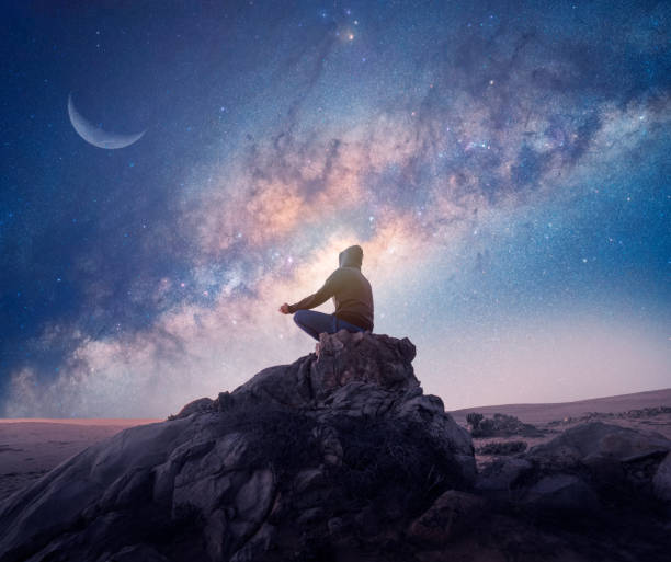 istock meditating under the Milky Way 1336099949