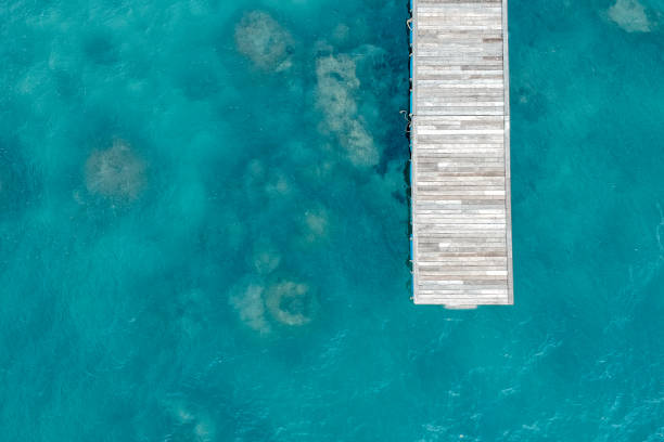 Jetty aerial top view Top view of jetty with clear sea water jetty aerial stock pictures, royalty-free photos & images