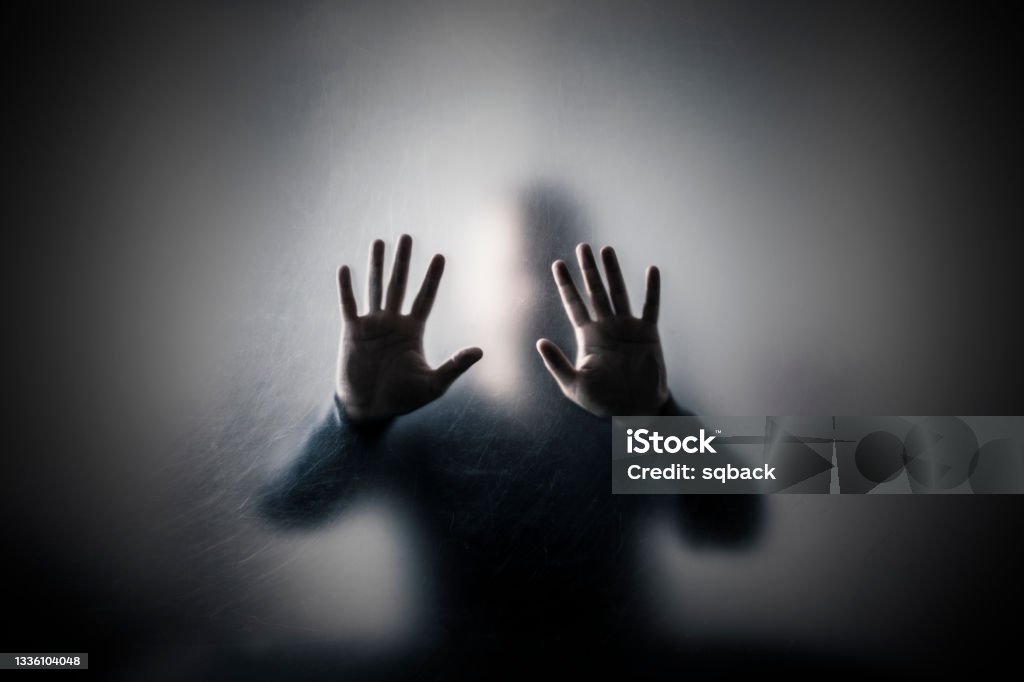 Man behind a scratched glass Terrified Stock Photo
