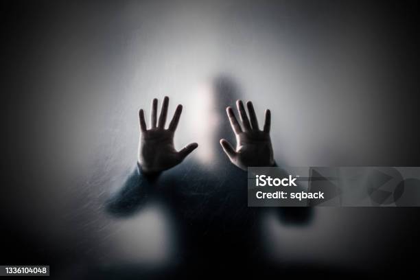 Man Behind A Scratched Glass Stock Photo - Download Image Now - Terrified, Trapped, In Silhouette