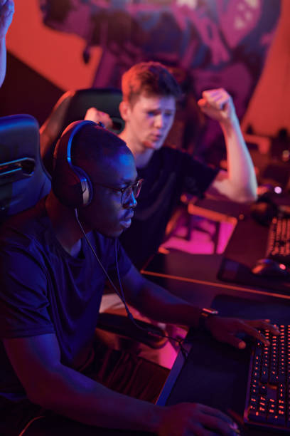istock Young man making yes gesture while cheering for esports team member completing level 1336104302