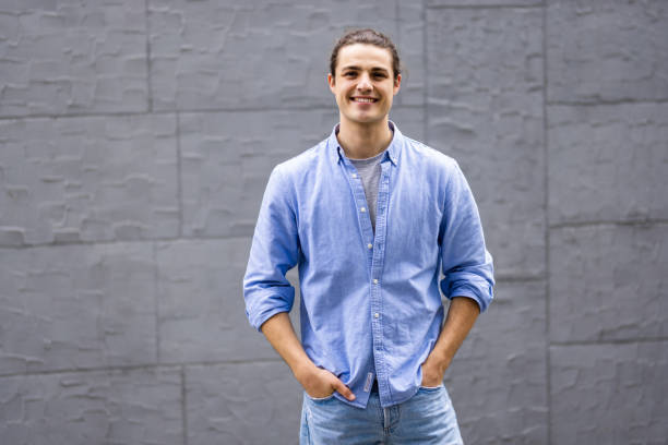 istock Handsome young man walking on the street and looking at camera. 1336105861