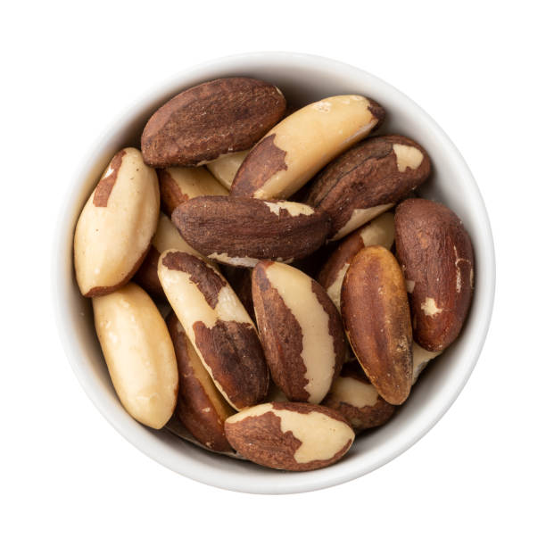 istock Brazil nuts in a bowl isolated over white background 1336109048