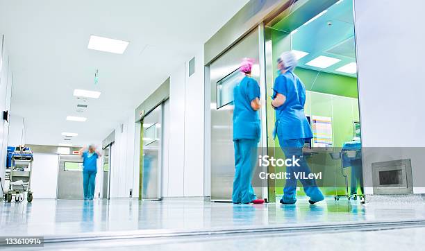 Surgeons Talk In A Hospital Corridor Stock Photo - Download Image Now - Hospital, Corridor, Nurse