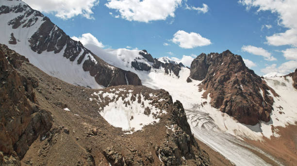 istock High rocky mountains covered with ice in places 1336109539