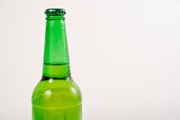istock green glass bottle covered with water drops. condensate 1336109704