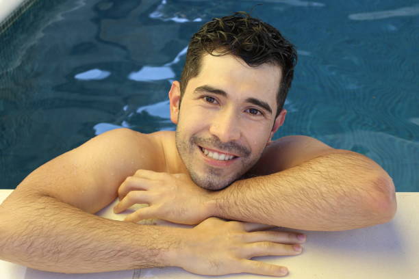 istock Young man relaxing in swimming pool 1336111109
