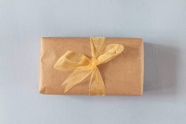 istock gift box from paper craft with ribbon isolated on blue background 1336112232
