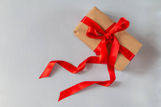 istock gift box from paper craft with ribbon isolated on blue background 1336112252