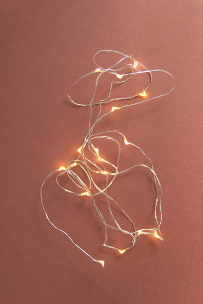 istock Light garland top view on brown background 1336112348