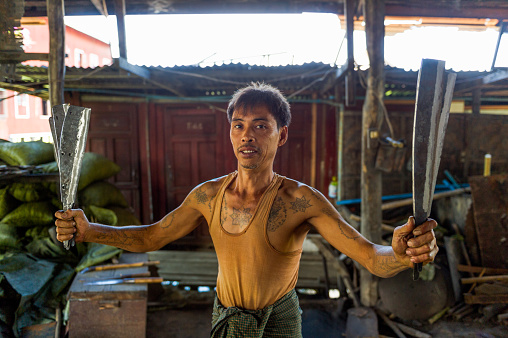 Myanmar. Inle lake. Shan state. Blacksmiths showing his knives