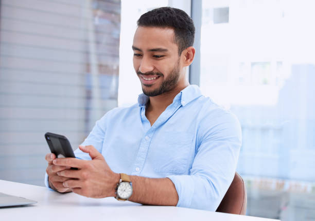 istock Shot of a young businessman using his smartphone to send a text message 1336113464