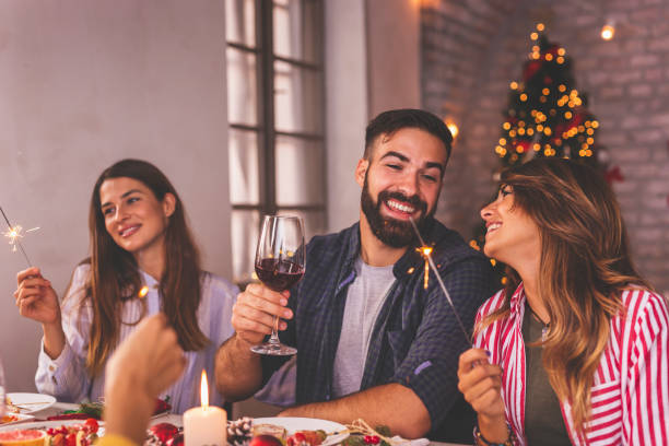 istock Friends holding sparklers during Christmas dinner 1336113884