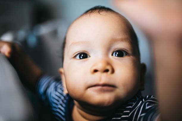 istock portrait asian baby standing and hold a bed frame 1336114957