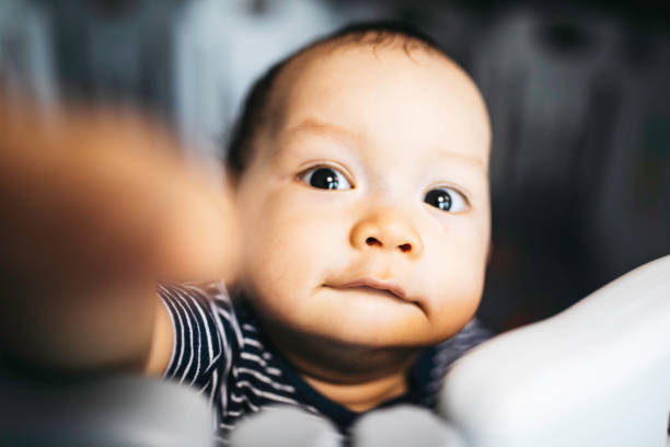 istock portrait asian baby standing and hold a bed frame 1336114963