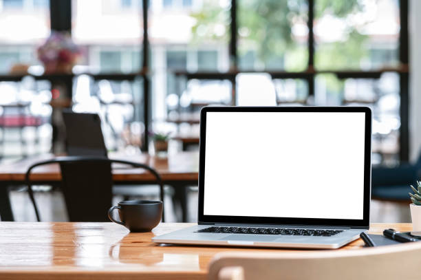 istock Mockup blank screen laptop computer on wooden table in cafe room. 1336115279