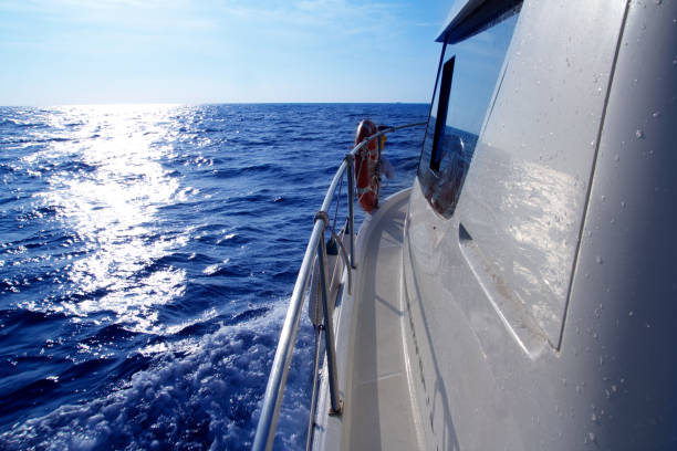 istock Boat side sailing in blue sea sun reflection 1336118295