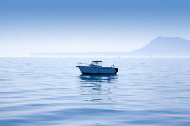 boat fishing in Mediterranean Denia sea with Mongo mountain