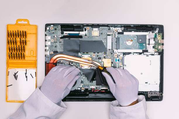 istock View from above of a white gloved hands of an engineer, fixing a laptop on a white table 1336120579