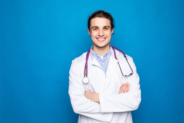 istock Male doctor man isolated on blue background. 1336121224