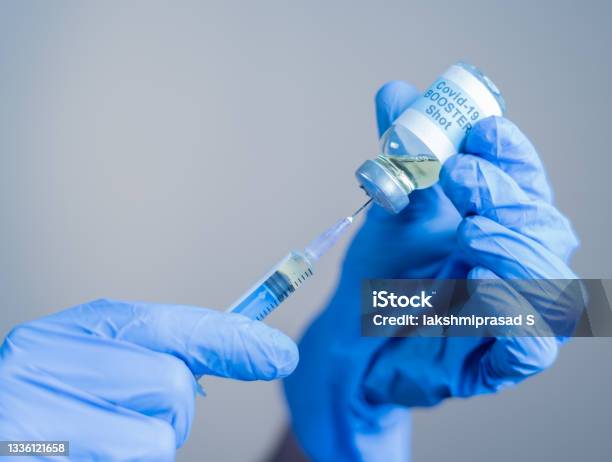 Focus On Syringe Close Up Of Doctor Or Nurse Hands Taking Covid Vaccination Booster Shot Or 3rd Dose From Syringe Stock Photo - Download Image Now