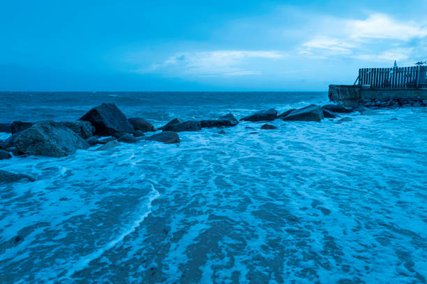 Beach flood and surging seawater on Cape Cod coastal area during Tropical Storm Henri in August 2021.