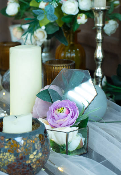 istock transparent box with a lilac rose. Candles on the table. An example of a romantic table setting. 1336123154