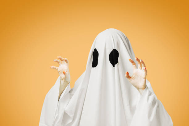 istock Cute white ghost with spooky gesture in Halloween. 1336124236