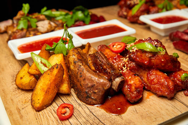 istock Pork ribs with baked potatoes and tomato sauce 1336127626