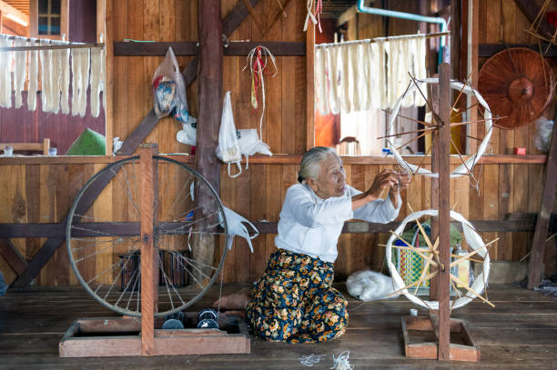 Myanmar. Inle lake. Shan state. Woman working at weaving. The weaving of lotus Silk fabric from the stalks of the lotus plant is a local industry