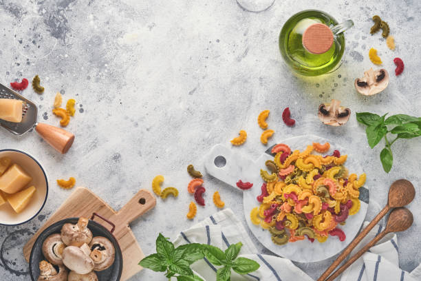 pasta. italian pasta. insalata di pasta and vegetables cooking ingredients, cheese, mushrooms and basil on old stone background. italian food cooking ingredients. top view with copy space. - cooking oil olive oil nutritional supplement spoon imagens e fotografias de stock