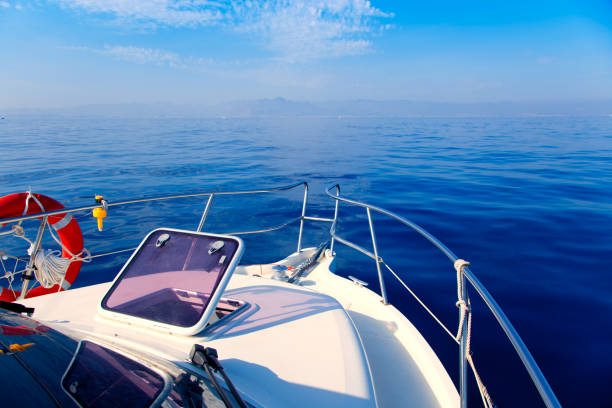 istock Blue sea boat sailing with open bow porthole 1336134660
