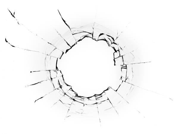 istock Hole from a ball in the glass, cracks on a white background 1336135763