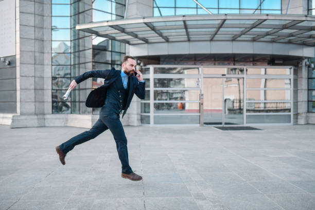 istock Businessman Running To Catch Cab After Work 1336135874