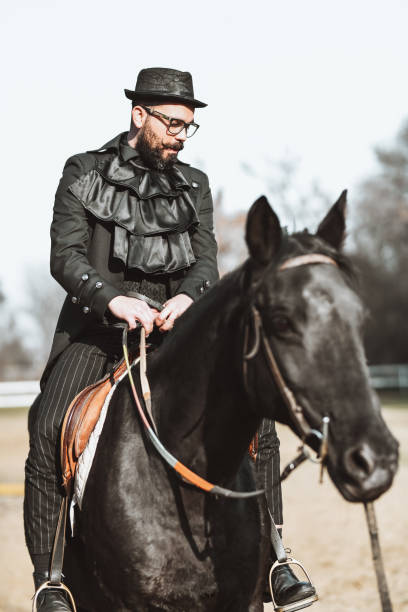 istock Spanish Nobleman Riding Black Steed On Ranch 1336136022
