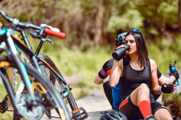 istock Couple Relaxing And Drinking Water During Cycling Adventure 1336137130