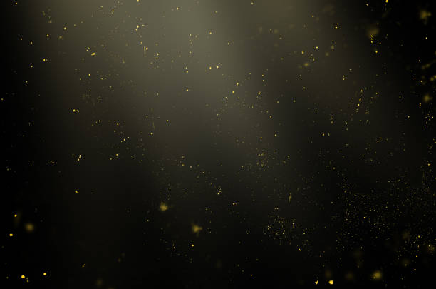 particules dorées dans les rayons de lumière sur un fond noir pour une utilisation avec le mode de superposition d’écran - dust photos et images de collection