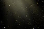 golden particles in the rays of light on a black background for use with the screen overlay mode