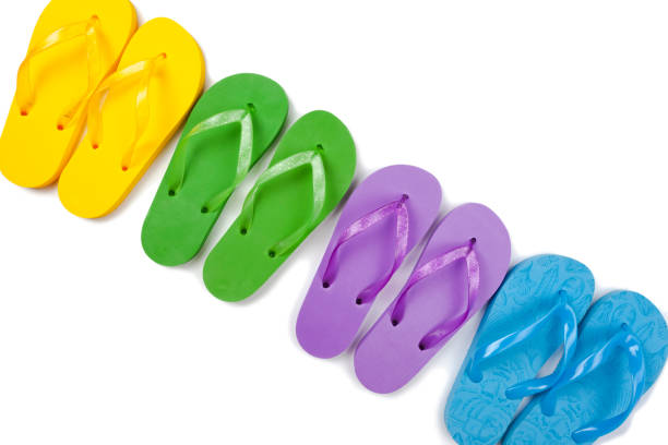 istock four pairs of multicolored rubber beach flip flops in a row on a white background, isolate 1336138879