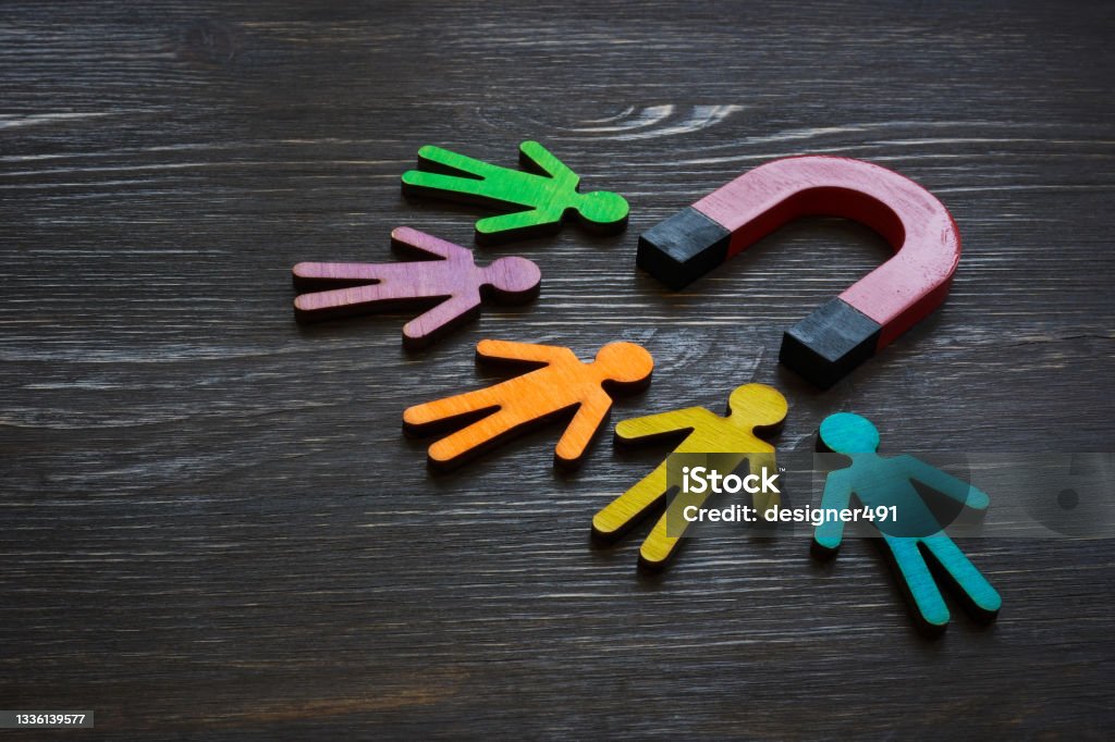 Magnet and figures of people. Customer acquisition and retention. Employee Stock Photo