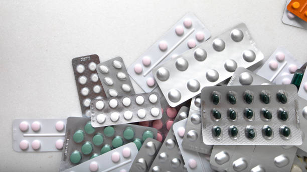 istock Plates with pills and capsules on a white background with space for text. Banner 1336139785