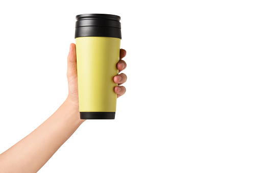 A male hand holding insulated drink container, travel mug (Clipping Path) on the white background with copy space