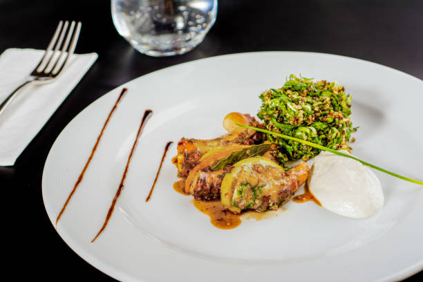 istock Grilled octopus with quinoa salad on a white porcelain plate. 1336142245