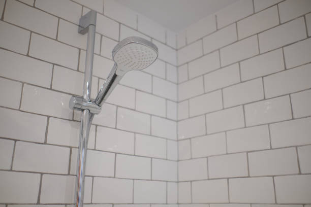 istock Modern shower with white tiles, handheld shower head. 1336142589