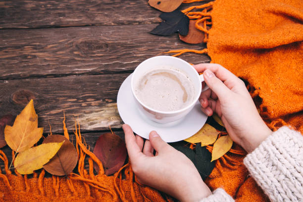 istock coffee and autumn leaves on a wooden background 1336144182