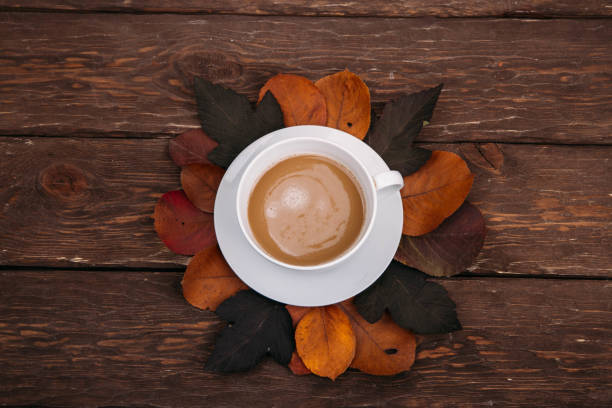 istock coffee and autumn leaves on a wooden background 1336144192