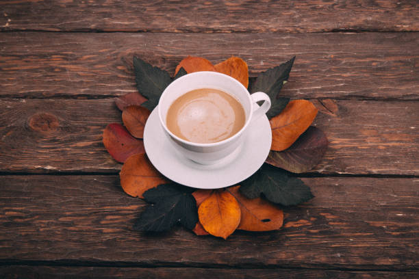 istock coffee and autumn leaves on a wooden background 1336144196
