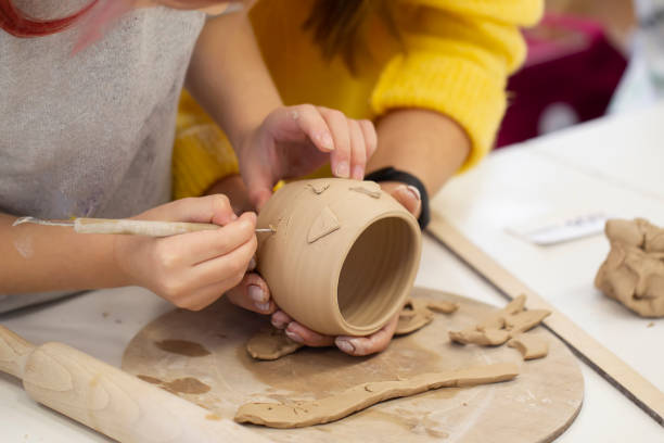 istock The child's hands make a clay cup. Master class on making clay products. 1336145144